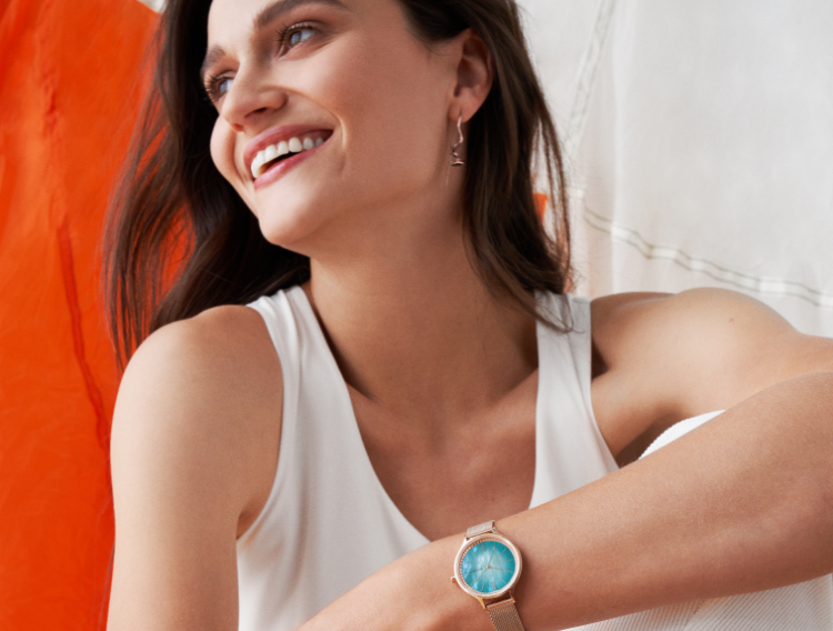 Silver case, blue dial, brown leather strap. Black bracelets with silver accents.