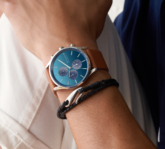 Silver-tone case with matching mesh strap and blue dial.