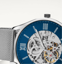 Silver case with matching mesh strap and blue dial.