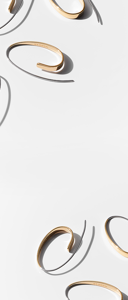 a collection of skagen earrings on a gray background