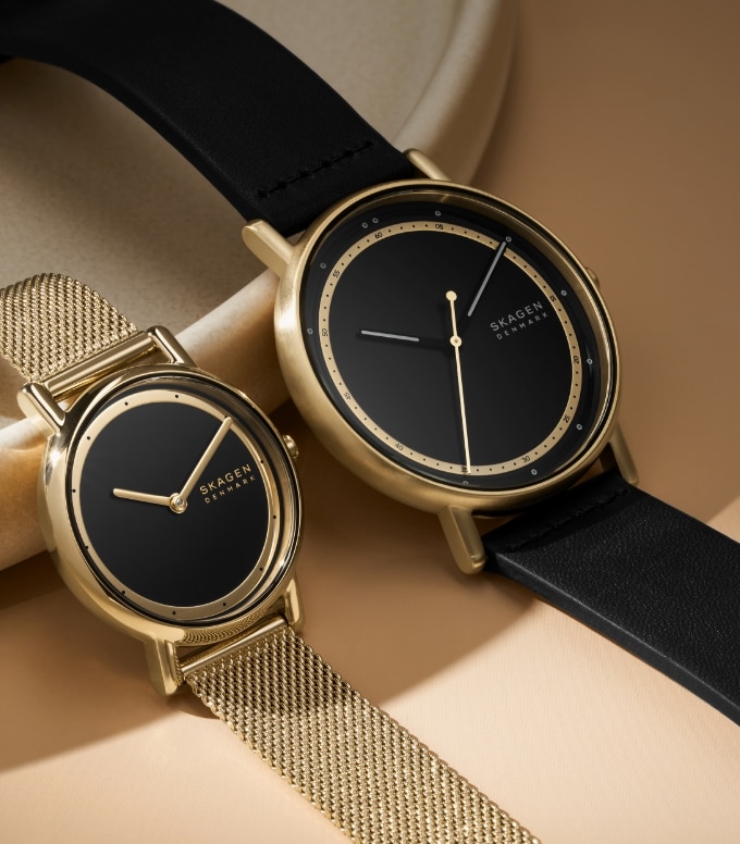 Two Skagen watches in black and gold.