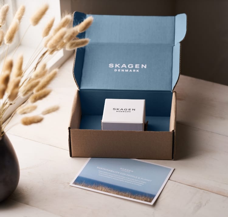 A Skagen product box inside of an open Skagen delivery box