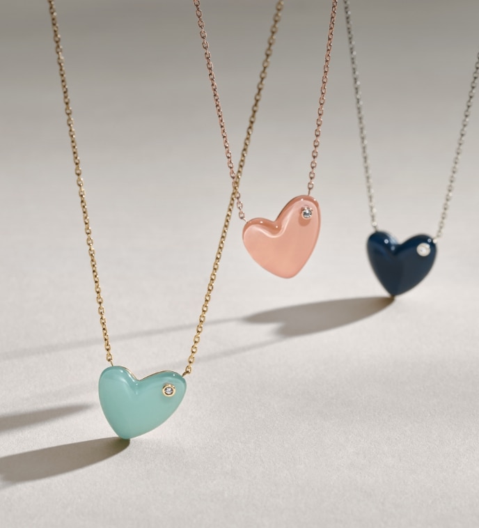Image of the entire heart necklace collection in three colourways.
