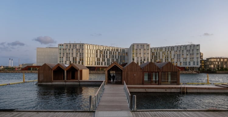 Image of a building and a dock on the waterfront.