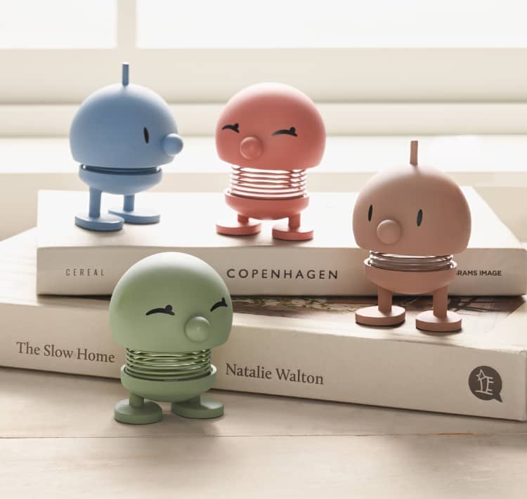 wooden hoptimists on a stack of books