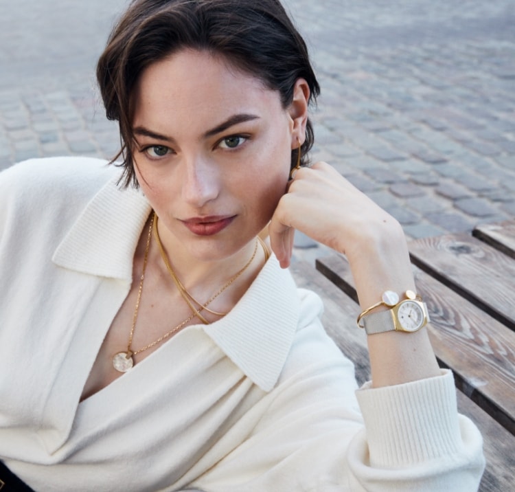 Image of a woman wearing Skagen watches and jewelry