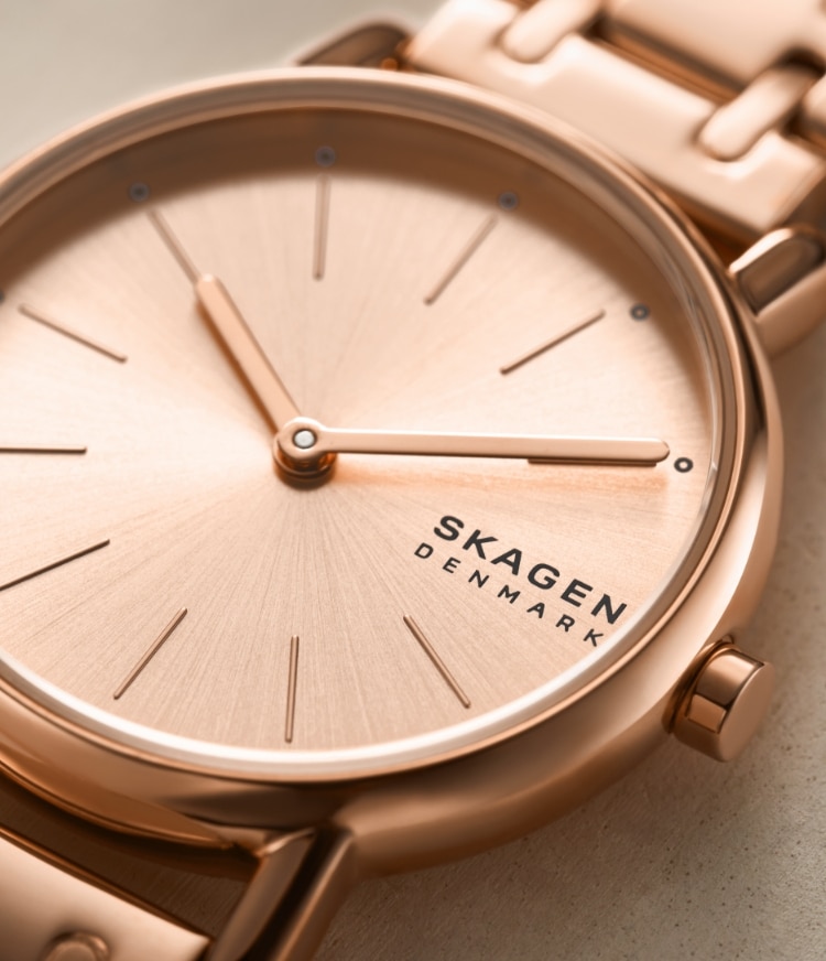 Image of a woman wearing a rose gold-tone Signatur watch.