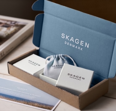 A Skagen product box inside of an open Skagen shipping box