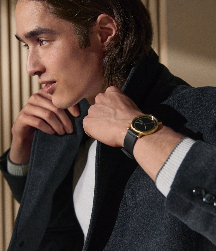 Male model with black and gold tone Skagen watch.
