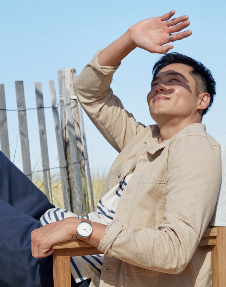 Image of a man wearing a solar-powered watch on a beach - Working Toward a Greater Goal