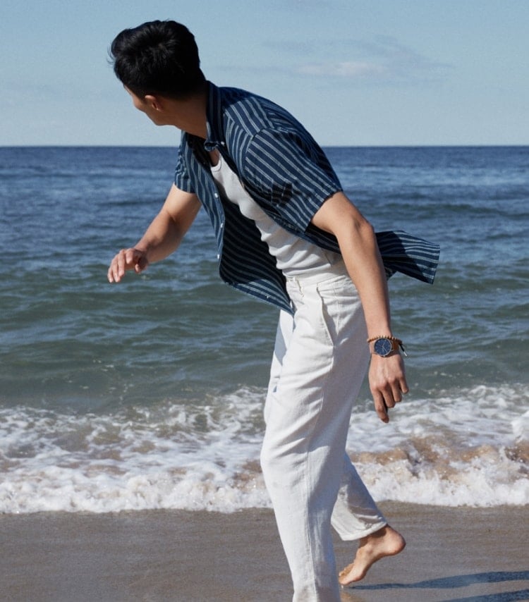 Man on a beach wearing a Skagen watch and bracelet 