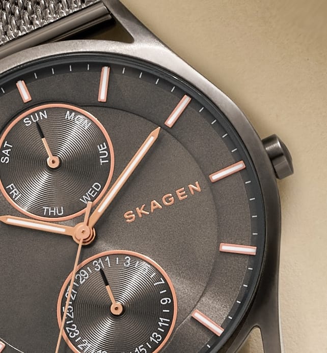 Multiple images showing black & gold Skagen watches.