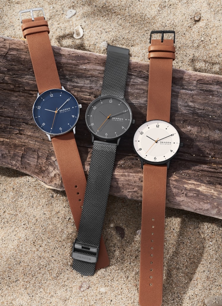 Image of three Riss watches on the beach