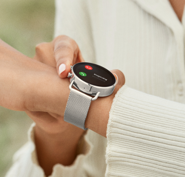 Image of woman answering her phone on her watch.