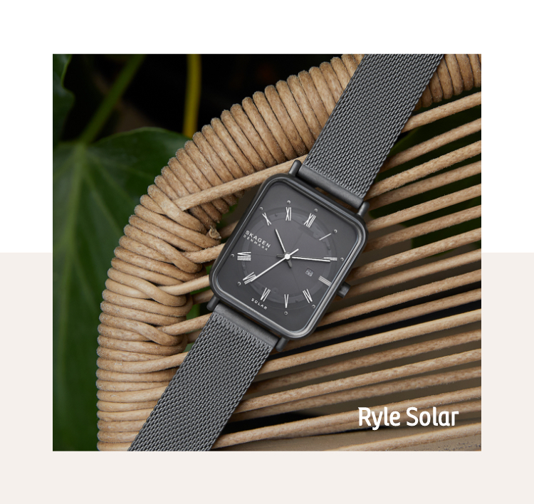 Image of Ryle Solar on a wooden surface. Image of green grass and blue sky.