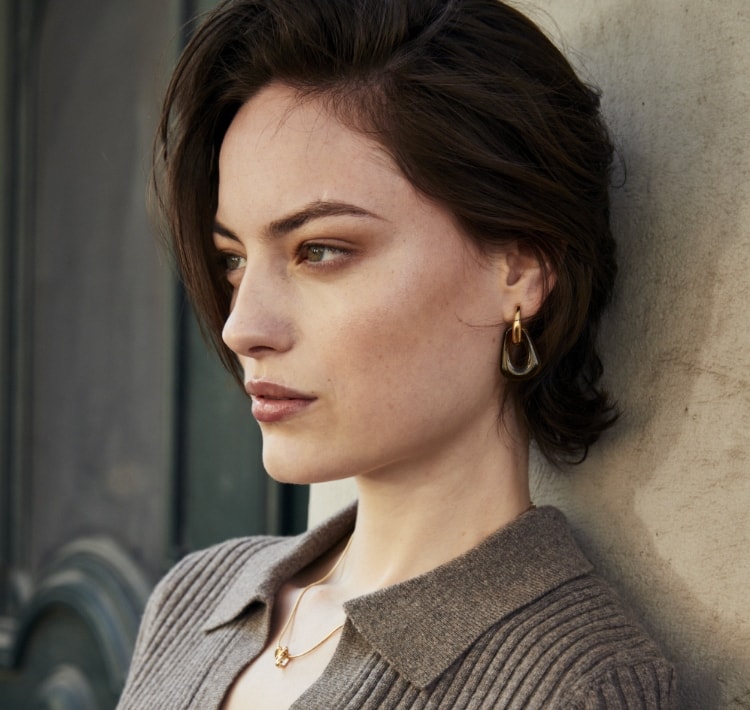 Image of a woman wearing CLED X SKAGEN earrings